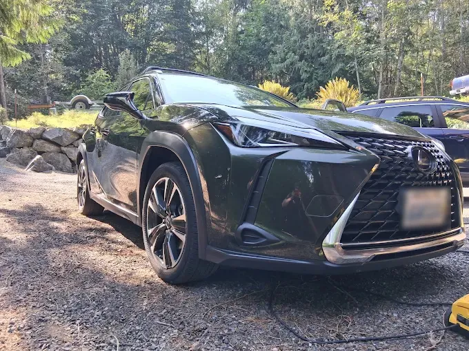 Black Lexus UX on a gravel driveway after a detail